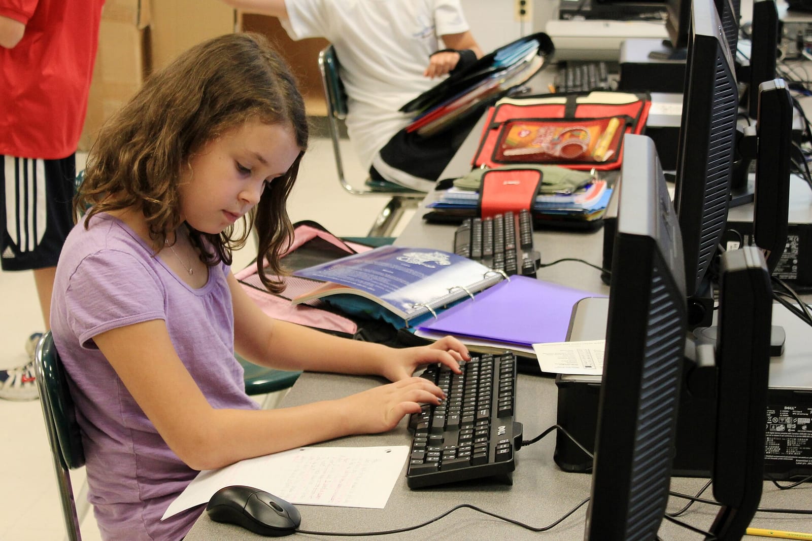 A fifth-grade pupil typing on a computer during a class at a public elementary school