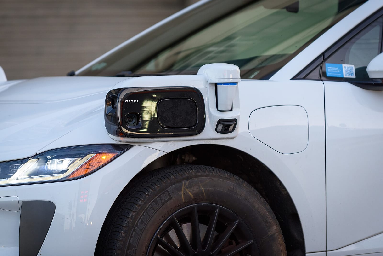 Close-up of the camera and sensor pod mounted on the side of a Waymo self-driving Jaguar I-Pace