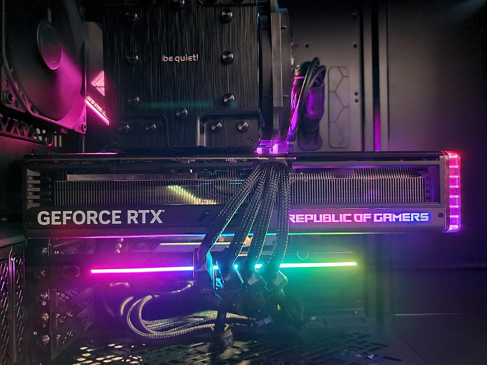 Asus ROG Strix GeForce RTX 4090 graphics card installed and lit up inside a PC case